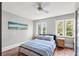 Comfortable bedroom featuring two windows, a ceiling fan, light grey walls, and wood floors at 146 8Th Ne Ave, St Petersburg, FL 33701