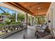Relaxing covered porch with stone columns, wood ceiling, and comfortable seating overlooking the landscaped yard at 146 8Th Ne Ave, St Petersburg, FL 33701