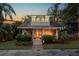 Inviting two-story home with a cozy front porch, stone pillars, and lush greenery at 146 8Th Ne Ave, St Petersburg, FL 33701