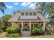 Charming two-story home featuring a stone facade, covered front porch, and well-manicured landscaping at 146 8Th Ne Ave, St Petersburg, FL 33701