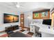 Home office with a ceiling fan, media, desk, a view to the tropical outdoors, and unique floors at 146 8Th Ne Ave, St Petersburg, FL 33701