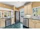 Kitchen with stainless steel appliances and adjacent seating area; access to pool at 146 8Th Ne Ave, St Petersburg, FL 33701