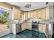 Kitchen featuring stainless steel appliances, neutral cabinetry, and view of landscaped yard at 146 8Th Ne Ave, St Petersburg, FL 33701