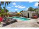 Inviting pool area with lounge chairs, tropical landscaping, and sunny skies at 146 8Th Ne Ave, St Petersburg, FL 33701