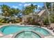 Beautiful backyard featuring a pool, spa, palm trees, and tropical landscaping at 146 8Th Ne Ave, St Petersburg, FL 33701