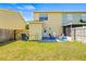 Well-maintained backyard with a patio and green lawn, offering plenty of space and outdoor living at 1577 Chateaux De Ville Ct, Clearwater, FL 33764
