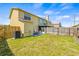 Large grassy backyard with a patio seating area, creating a serene outdoor space at 1577 Chateaux De Ville Ct, Clearwater, FL 33764
