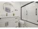 Modern bathroom with a white vanity, round mirror, and subway tile shower with black trim for a sleek design at 1577 Chateaux De Ville Ct, Clearwater, FL 33764