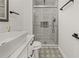 Contemporary bathroom with vessel sink, sleek fixtures, and patterned floor tiles next to a glass shower with subway tile at 1577 Chateaux De Ville Ct, Clearwater, FL 33764