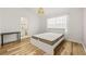 Bright bedroom with a modern bed frame, hardwood floors, and ensuite bathroom access at 1577 Chateaux De Ville Ct, Clearwater, FL 33764