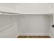 Bright walk-in closet with ample shelving and a clean, minimalist design, perfect for organized storage at 1577 Chateaux De Ville Ct, Clearwater, FL 33764