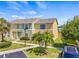 Charming townhome exterior with well-manicured lawn, showcasing curb appeal and inviting entryway at 1577 Chateaux De Ville Ct, Clearwater, FL 33764