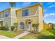 Charming home featuring a well-maintained lawn, arched window, and inviting front entrance at 1577 Chateaux De Ville Ct, Clearwater, FL 33764