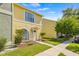 Inviting exterior of the home featuring a well-maintained yard, walkway and colorful landscaping at 1577 Chateaux De Ville Ct, Clearwater, FL 33764