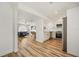 Open concept living area with hardwood floors and white accents adjacent to kitchen at 1577 Chateaux De Ville Ct, Clearwater, FL 33764