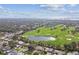 Breathtaking aerial view of a sprawling golf course community, featuring a scenic pond and mature trees at 1714 Cypress Ave, Belleair, FL 33756