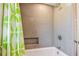 Stylish bathroom features modern shower with gray tiled walls and built-in niche, plus a colorful shower curtain at 1714 Cypress Ave, Belleair, FL 33756