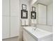 Modern bathroom features a vanity, a sleek mirror, framed certificates on the wall, and decorative towels at 1714 Cypress Ave, Belleair, FL 33756