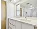 Modern bathroom features sleek vanity with integrated sink, large mirror and bright lighting at 1714 Cypress Ave, Belleair, FL 33756