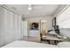 Light-filled bedroom with ceiling fan, closet, and a workstation for study or work, plus eclectic decor at 1714 Cypress Ave, Belleair, FL 33756