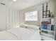 Bright bedroom featuring minimalist decor, a queen-sized bed, and closet at 1714 Cypress Ave, Belleair, FL 33756