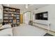 Cozy bedroom features a ceiling fan, built-in shelving, work desk, and TV for relaxation and entertainment at 1714 Cypress Ave, Belleair, FL 33756