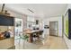 Open dining area with a large dining table, adjacent to the modern kitchen at 1714 Cypress Ave, Belleair, FL 33756