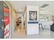Modern entryway with unique art, sleek flooring, and an open view into the living spaces at 1714 Cypress Ave, Belleair, FL 33756