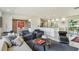 Bright, open living room with modern furnishings, art, and a seamless flow into the kitchen at 1714 Cypress Ave, Belleair, FL 33756