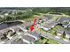Expansive aerial view of a two-story home in a lakeside community with lush landscaping and a trampoline in the backyard at 17737 Everlong Dr, Land O Lakes, FL 34638