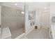 Modern bathroom with a walk-in shower featuring gray tile, a shower seat, and a glass enclosure at 17737 Everlong Dr, Land O Lakes, FL 34638