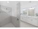 Elegant bathroom featuring a spacious shower with a glass enclosure and a double sink vanity at 17737 Everlong Dr, Land O Lakes, FL 34638