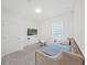 Cozy bedroom with a daybed, soft lighting, and a TV mounted on the wall at 17737 Everlong Dr, Land O Lakes, FL 34638
