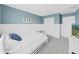 Charming bedroom featuring blue walls, white accents, a comfortable bed, and stylish decor at 17737 Everlong Dr, Land O Lakes, FL 34638