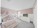 Cozy ' bedroom with a canopy bed, soft pink accents, and a TV at 17737 Everlong Dr, Land O Lakes, FL 34638