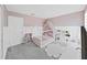 Charming bedroom with a playful decor including a canopy bed and toy kitchen at 17737 Everlong Dr, Land O Lakes, FL 34638