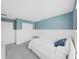 Charming bedroom featuring blue walls, white accents, a comfortable bed, and stylish decor at 17737 Everlong Dr, Land O Lakes, FL 34638