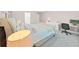 Spacious bedroom with modern decor, plush bed, desk and computer station in a well-lit space at 17737 Everlong Dr, Land O Lakes, FL 34638