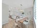 Dining area with a modern light fixture that is open to the kitchen and living room for easy entertaining at 17737 Everlong Dr, Land O Lakes, FL 34638