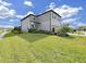 Well-manicured lawn complements the two-story home's exterior, featuring gray siding, a two-car garage, and tasteful landscaping at 17737 Everlong Dr, Land O Lakes, FL 34638