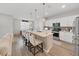Modern kitchen features an island with bar seating and stainless steel appliances, perfect for entertaining guests at 17737 Everlong Dr, Land O Lakes, FL 34638