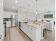 Entertain in style in this kitchen with a quartz island with bar seating and stainless steel appliances at 17737 Everlong Dr, Land O Lakes, FL 34638