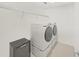 Bright laundry room with modern appliances and a mini-refrigerator at 17737 Everlong Dr, Land O Lakes, FL 34638