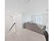Bright and airy living room with a sectional couch, large window, and soft carpet at 17737 Everlong Dr, Land O Lakes, FL 34638
