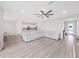 Open-concept living room features luxury vinyl flooring and a large sectional for comfortable living at 17737 Everlong Dr, Land O Lakes, FL 34638