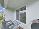 View of patio with chairs and outdoor grill with access to backyard and lawn at 17737 Everlong Dr, Land O Lakes, FL 34638