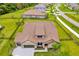 Aerial view of a charming single-Gathering home with a tile roof, stone accents, and lush landscaping at 17804 Brewster Grn, Lutz, FL 33559