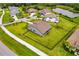 An aerial view shows the home's spacious lawn, fenced yard, and the community pond at 17804 Brewster Grn, Lutz, FL 33559