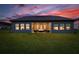 A backyard with a covered patio with comfortable seating and views of the night sky at 17804 Brewster Grn, Lutz, FL 33559