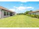 Expansive backyard, perfect for outdoor activities and relaxation, enclosed by a classic black fence at 17804 Brewster Grn, Lutz, FL 33559